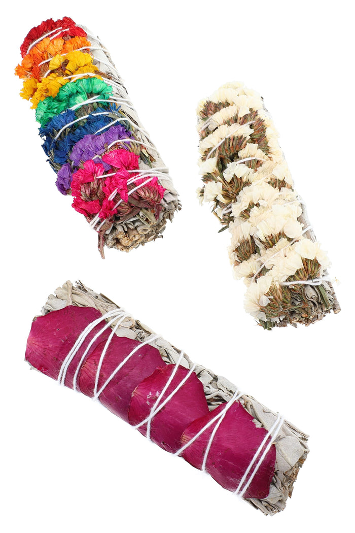 Trio of 4″ white sage smudge bundles with assorted floral wraps, including rainbow petals, cream blossoms, and deep rose petals.