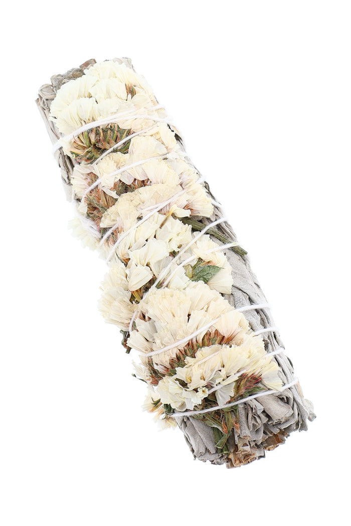 Close-up of 4″ white sage bundle wrapped with soft cream-colored blossoms and cotton string for home fragrance use.