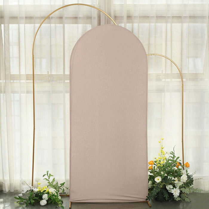 Neutral fabric backdrop with gold arch and floral arrangement.