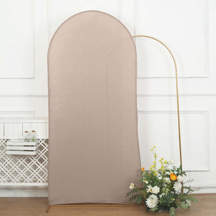 Beige fabric backdrop with gold arch stand and flower arrangement.