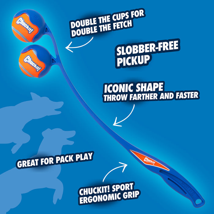A Chuckit! 22M Double Launcher Dog Toy features an ergonomic grip with two ball holders. Labels highlight: Double cups for double fetch, Slobber-Free Pickup, Iconic shape for farther throw, and Great for pack play. Playful dog silhouettes are in the background.