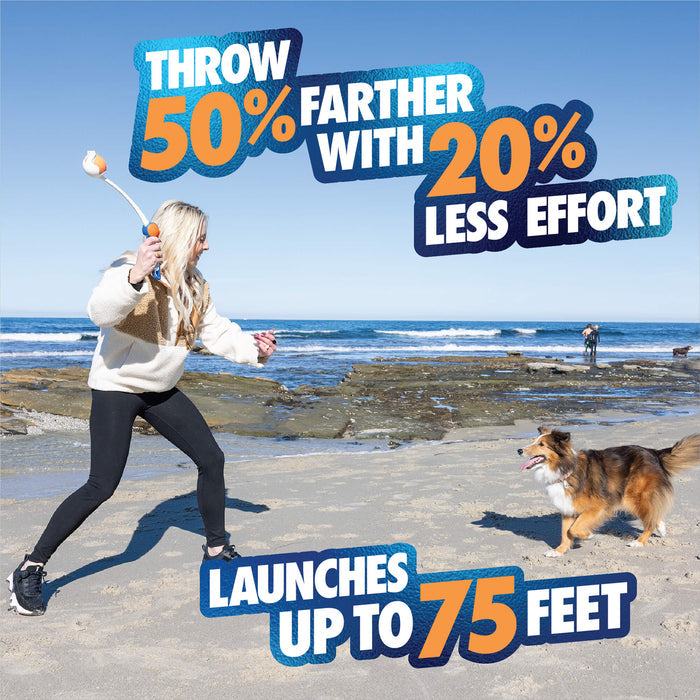 On a sandy beach, a woman uses the Chuckit! Ultra Launcher with Ultra Ball 18M by Chuckit! to throw a ball for her dog. Bold text: Throw 50% farther with 20% less effort—launches up to 75 feet. Ocean waves and rocks in the background.