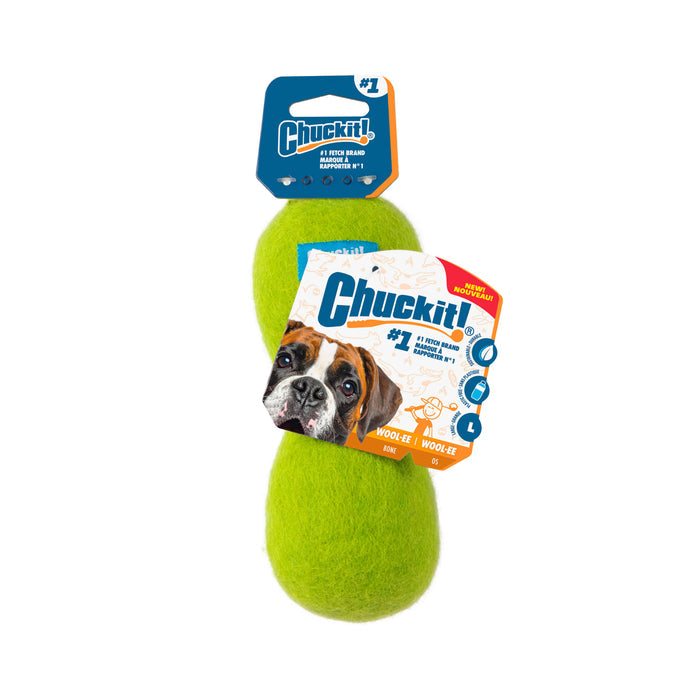 The Chuckit! Wool-ee Bone is an oval, bright green dog toy with fuzzy wool material, shown with attached packaging featuring the Chuckit! brand and a brown and white dog photo—ideal for dogs who enjoy natural wool toys.