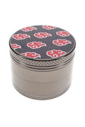 Assorted decal metal herb grinder parts with colorful leaf lid, screen, teeth, and scraper shown separately