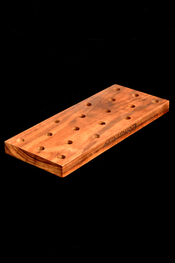 Low front angle of 18-slot wooden bowl rack filled with colorful glass bowls on a black background