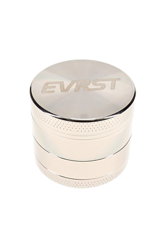 Polished EVRST metal herb grinder with engraved lid logo and textured grip bands