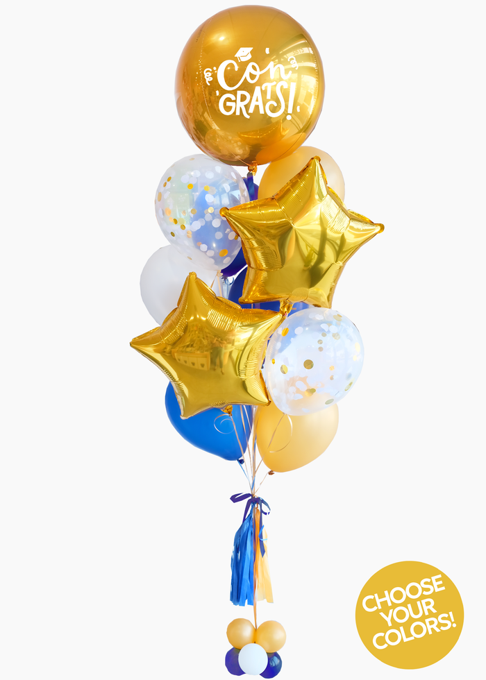 A balloon bouquet with a 'Congrats!' balloon, gold star-shaped foil balloons, blue and white latex balloons, and decorative elements arranged together.