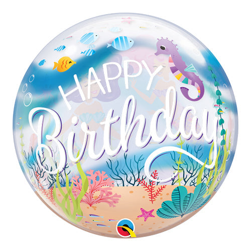 A round, clear bubble balloon with a printed design featuring mermaids, fishes, and sea plants, with the text 'Happy Birthday' on it.