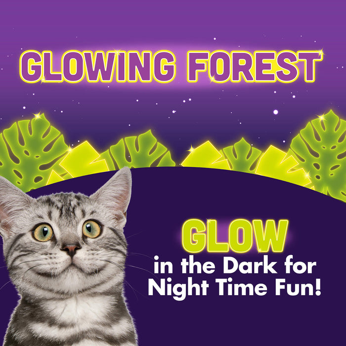 A gray tabby cat in front of neon green tropical leaves and a purple starry sky. Text: Quirky Kitty Glow Worm Kicker – Catnip & Silvervine Cat Toy by Quirky Kitty that glows at night for fun after dark!.