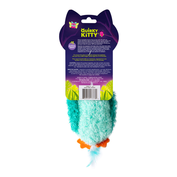 A fuzzy blue and teal Quirky Kitty Night Owl Kicker cat toy with orange feet and a feather tail, glows in the dark, contains catnip and silvervine, and is attached to purple Quirky Kitty packaging with product details and barcode on back.