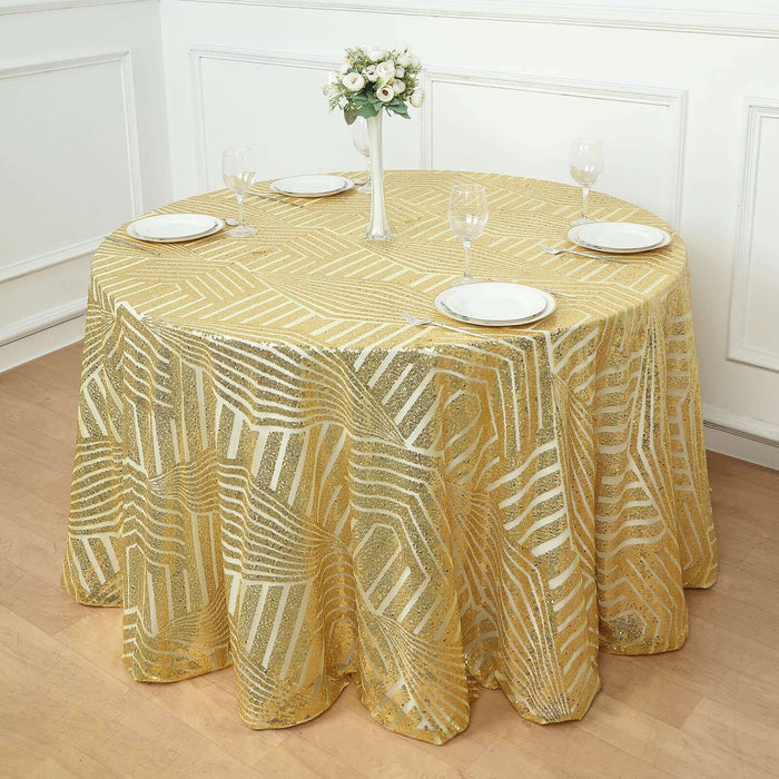 Gold geometric tablecloth on a round table with plates and glasses.