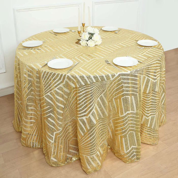 Gold geometric tablecloth draped on round table with plates and flowers.
