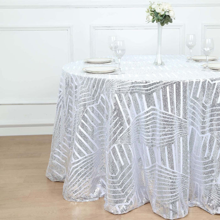 Sparkling silver sequin tablecloth with patterned design on a round table.