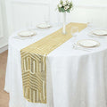 Gold sequin table runner on a white tablecloth with elegant dining setup.