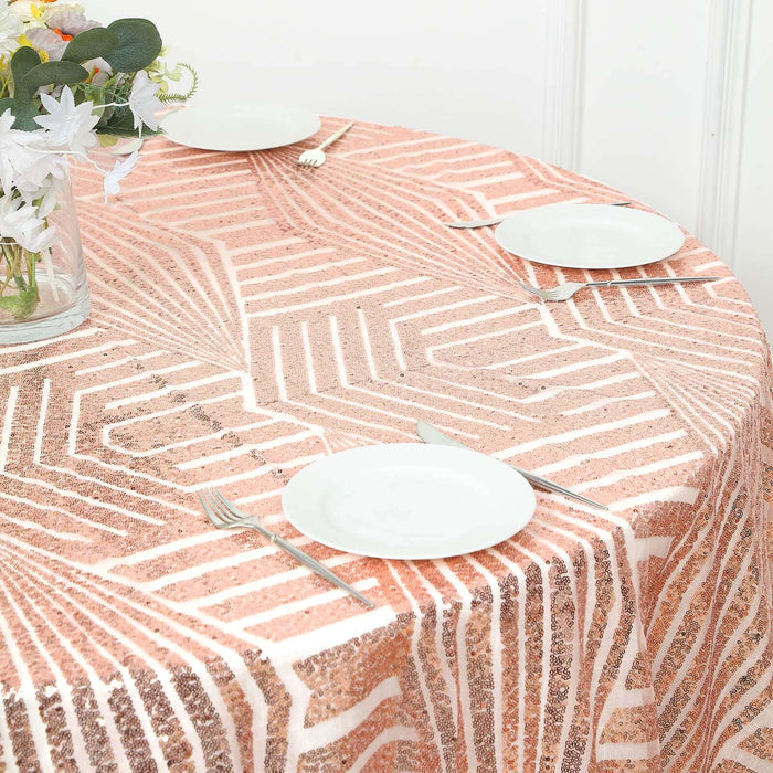 Round table with a geometric patterned tablecloth and white plates set for dining.