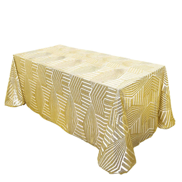 Gold patterned tablecloth on a plain backdrop.